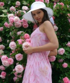 Eve Angel, brunette, strip, g-string, flowers, hat, outdoors