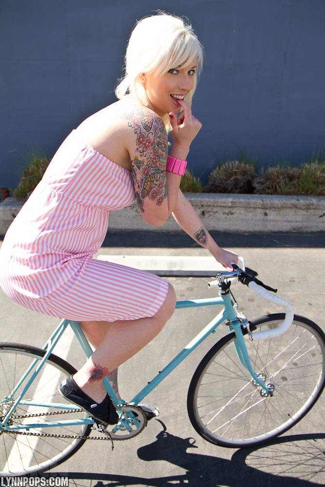 Lynn Pops, blonde, topless, dress, bicycle, tattoo